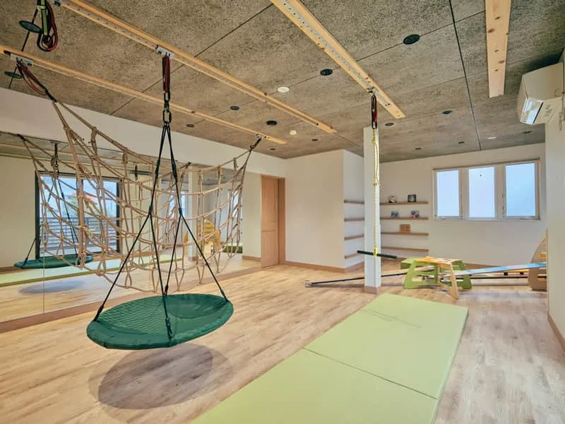 Indoor gym with rope net and climbing equipment