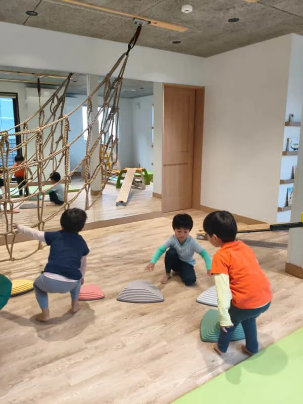 Children playing on balance stones