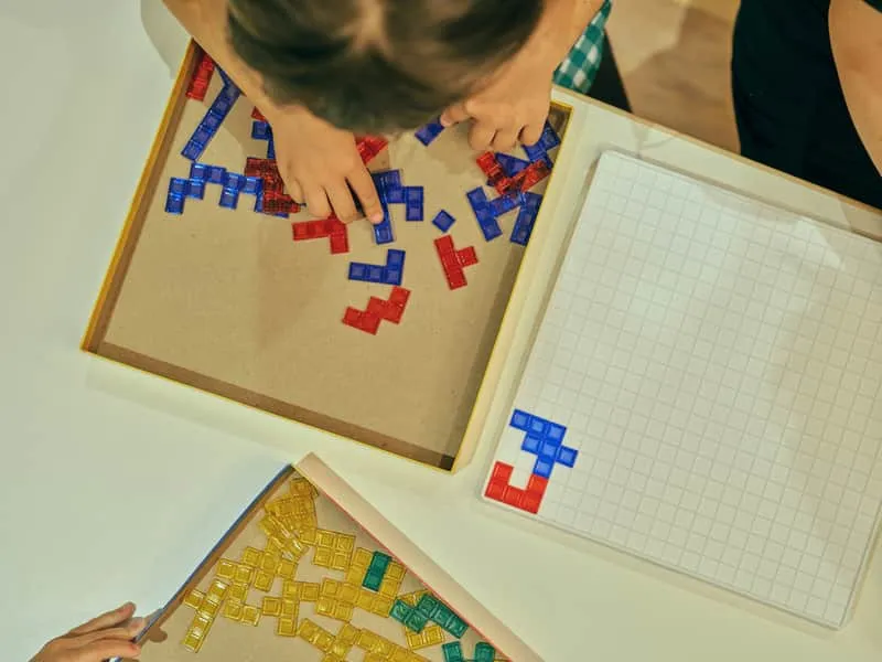 Child playing with colorful puzzle blocks
